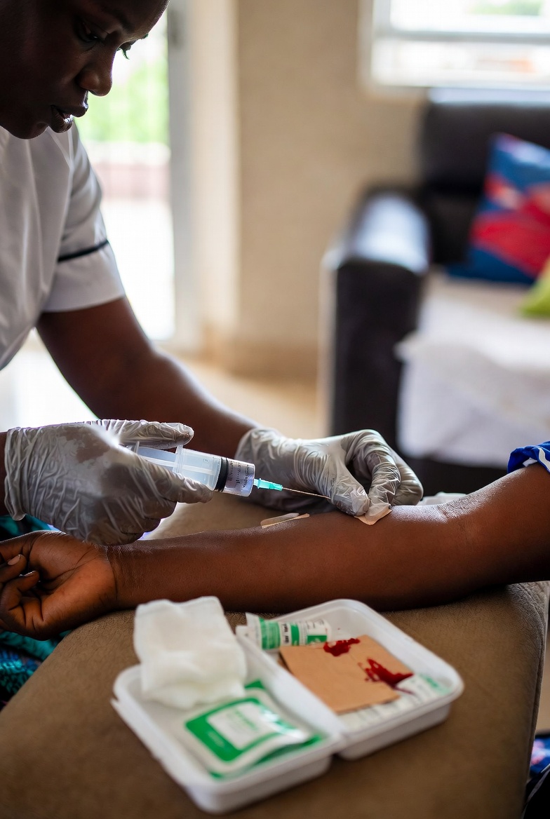 A nurse collecting a blood sample for a home lab test